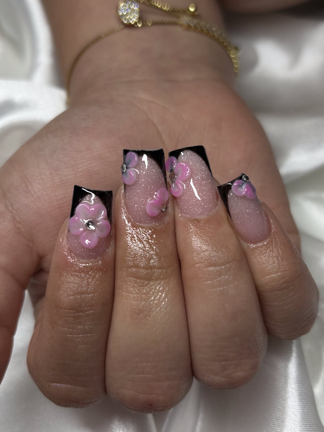 Black French tips with pink and lilac 3D flowers and glitter